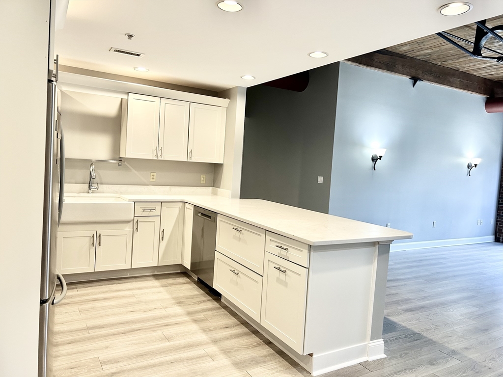 12 Brookside Road, Unit 3 Westford, MA 01886 - Photo 10 of 28 a kitchen with white cabinets and white appliances