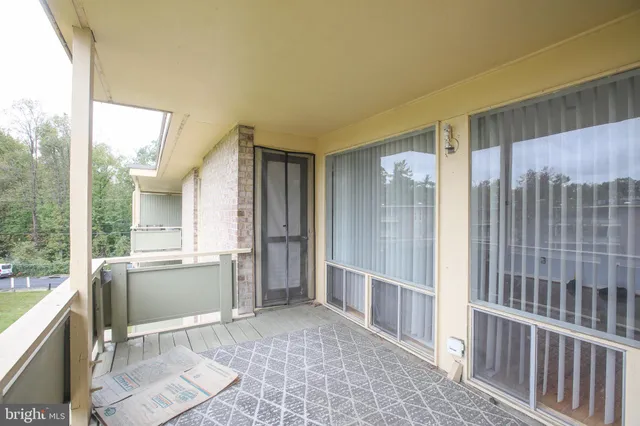 a view of an entryway with wooden floor and a sink