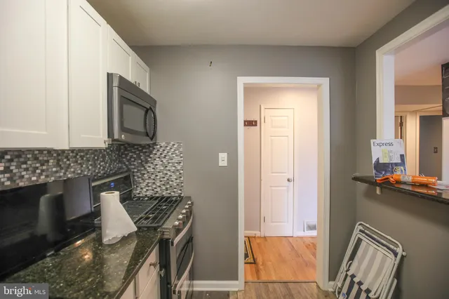 a kitchen with a refrigerator stove and microwave