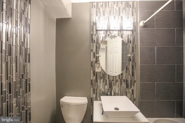 a bathroom with a toilet sink and shower