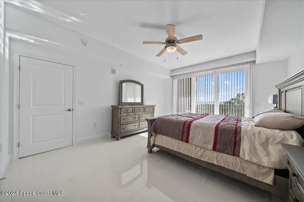 a bedroom with a bed dresser and a window