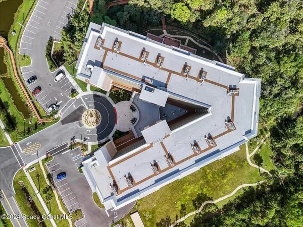 an aerial view of a house with a big yard and large trees