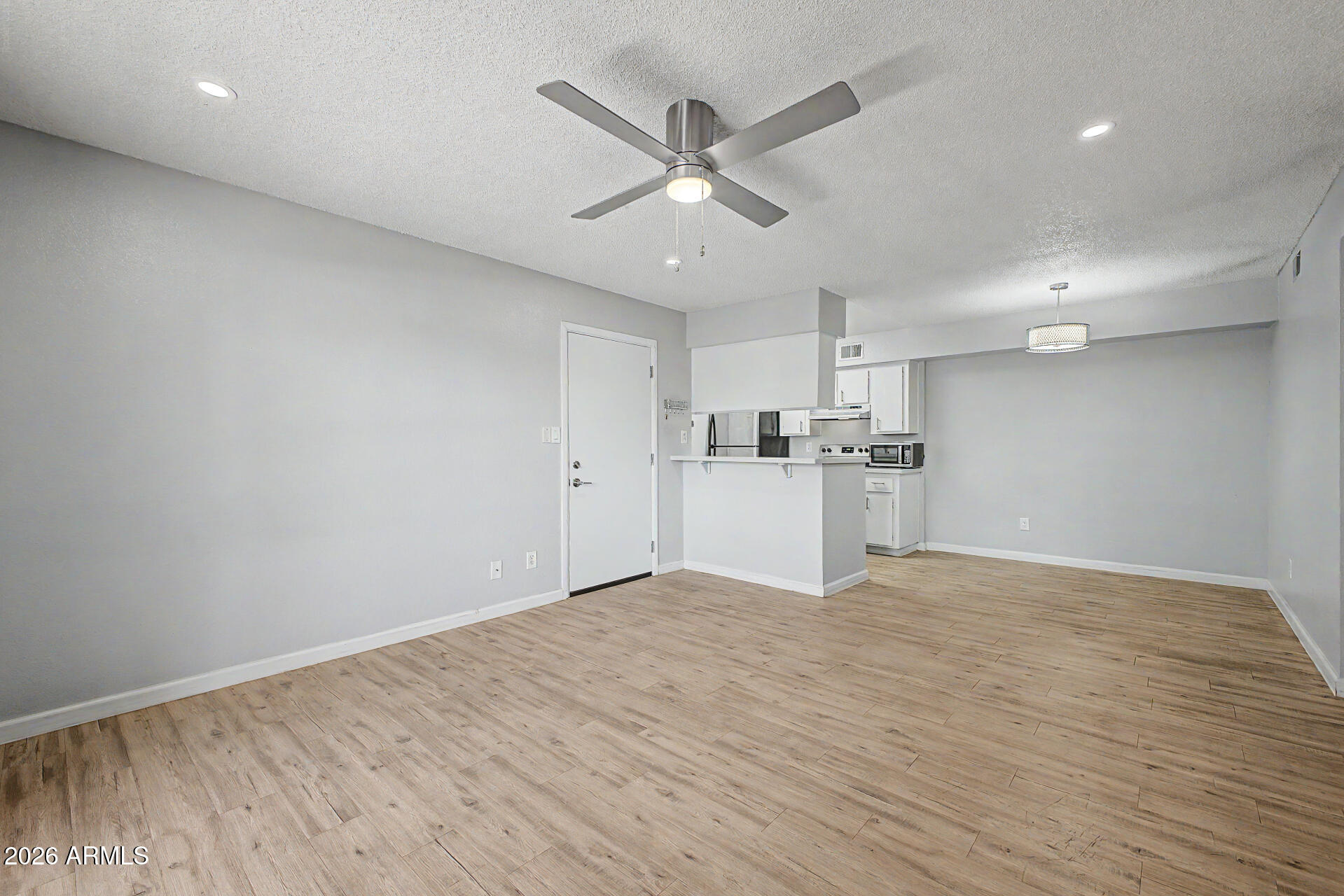 2625 East Indian School Road, Unit 227 Phoenix, AZ 85016 - Photo 10 of 31 a view of a kitchen with a sink and wooden floor