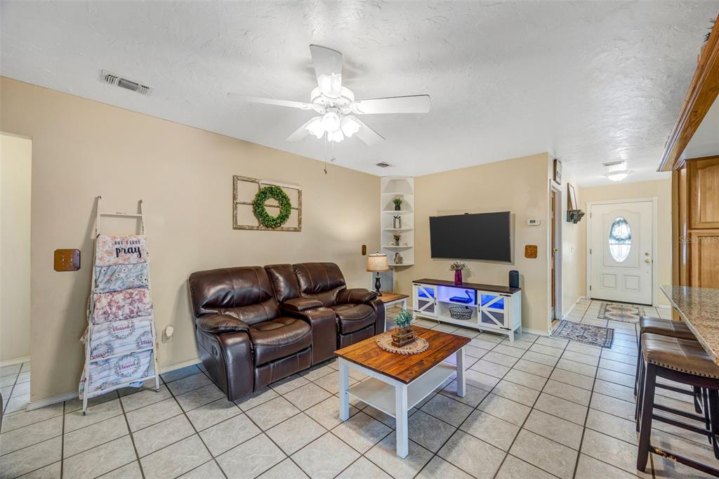 609 King Henry Court Seffner, FL 33584 - Photo 12 of 42 a living room with furniture and a flat screen tv
