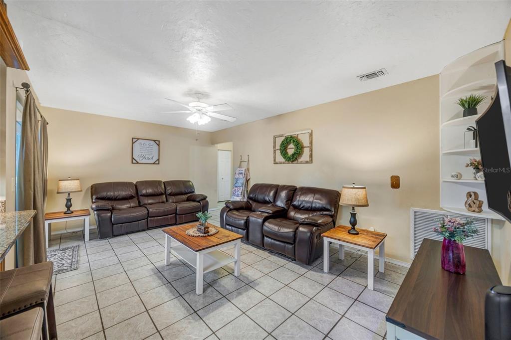 609 King Henry Court Seffner, FL 33584 - Photo 13 of 42 a living room with furniture and a flat screen tv
