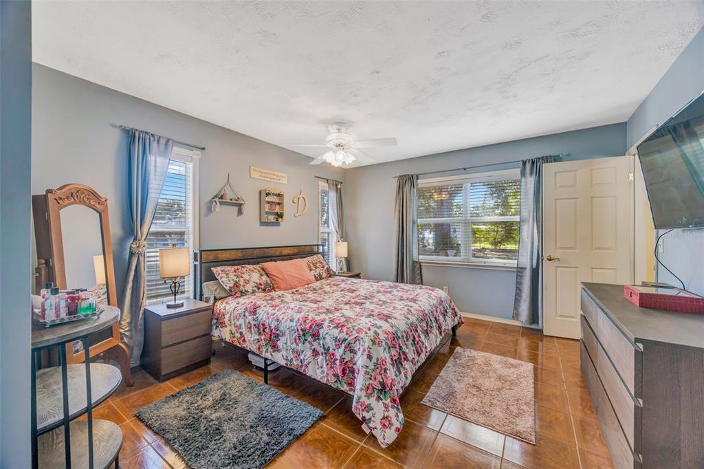 609 King Henry Court Seffner, FL 33584 - Photo 14 of 42 a bedroom with a bed wooden floor and window