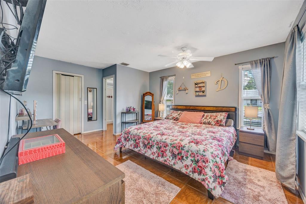 609 King Henry Court Seffner, FL 33584 - Photo 15 of 42 a bedroom with a bed and a chandelier