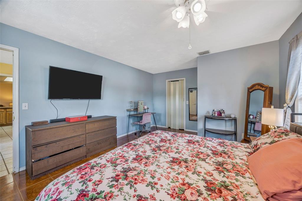 609 King Henry Court Seffner, FL 33584 - Photo 16 of 42 a bedroom with bed and flat screen tv