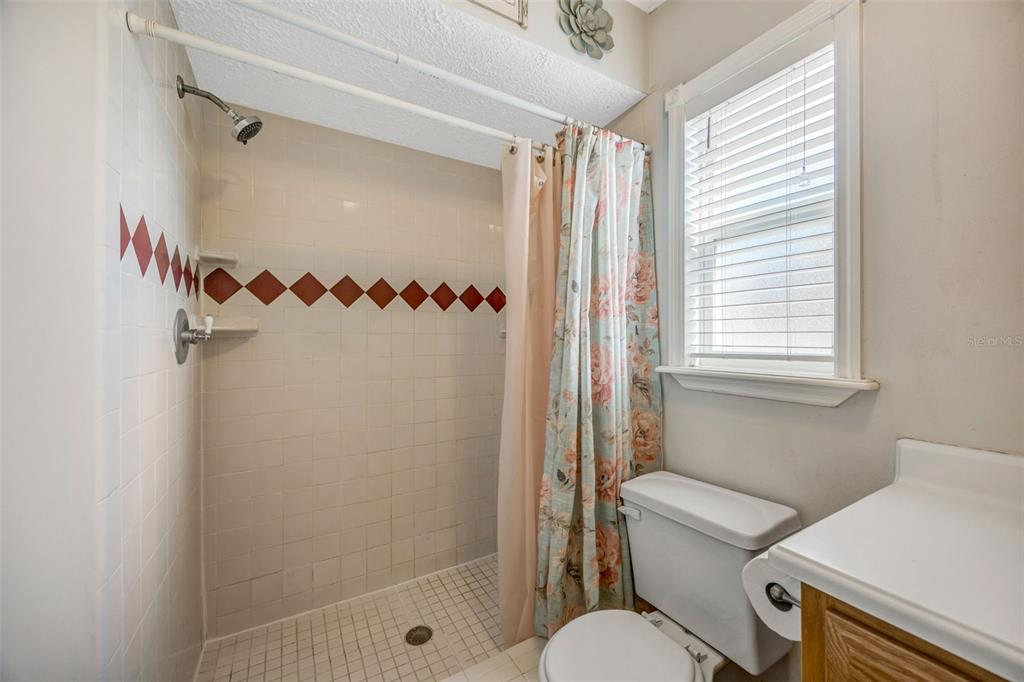 609 King Henry Court Seffner, FL 33584 - Photo 18 of 42 a bathroom with a toilet and a shower
