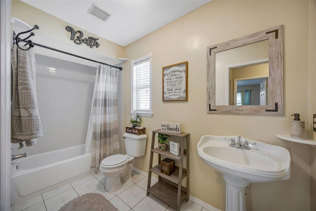 609 King Henry Court Seffner, FL 33584 - Photo 22 of 42 a bathroom with a sink toilet and shower