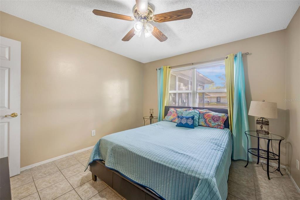 609 King Henry Court Seffner, FL 33584 - Photo 23 of 42 a bedroom with a bed and a window