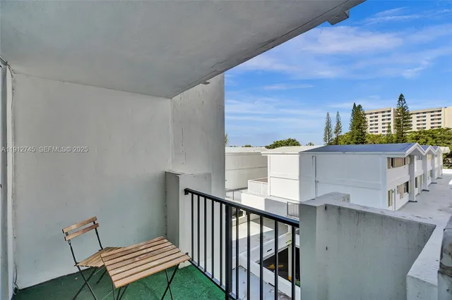 a view of a balcony with an outdoor seating