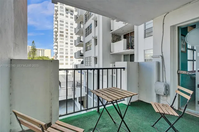 a balcony view with a chair and wooden floor