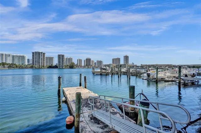 a view of a lake from a balcony with chairs