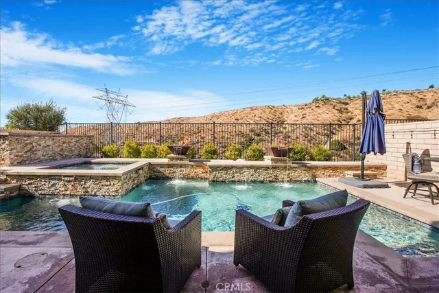 a front view of a house with porch and sitting area