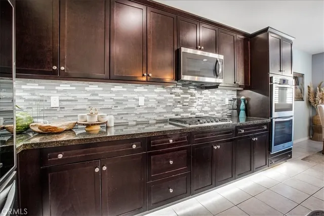 a kitchen with a sink appliances and cabinets