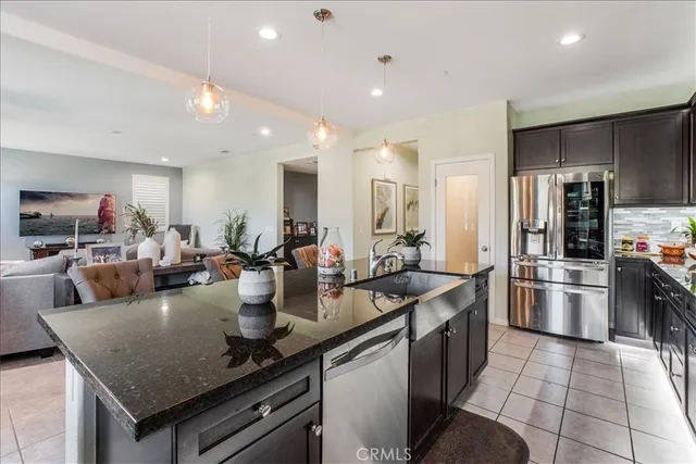 a kitchen with sink refrigerator and microwave