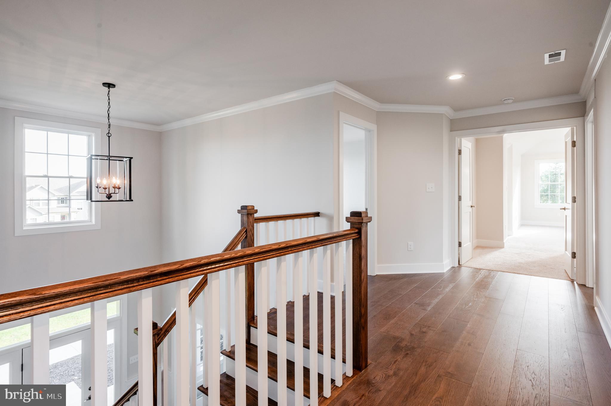 114 Orchard Road Perkasie, PA 18944 - Photo 11 of 17 a view of a hallway with wooden floor and staircase