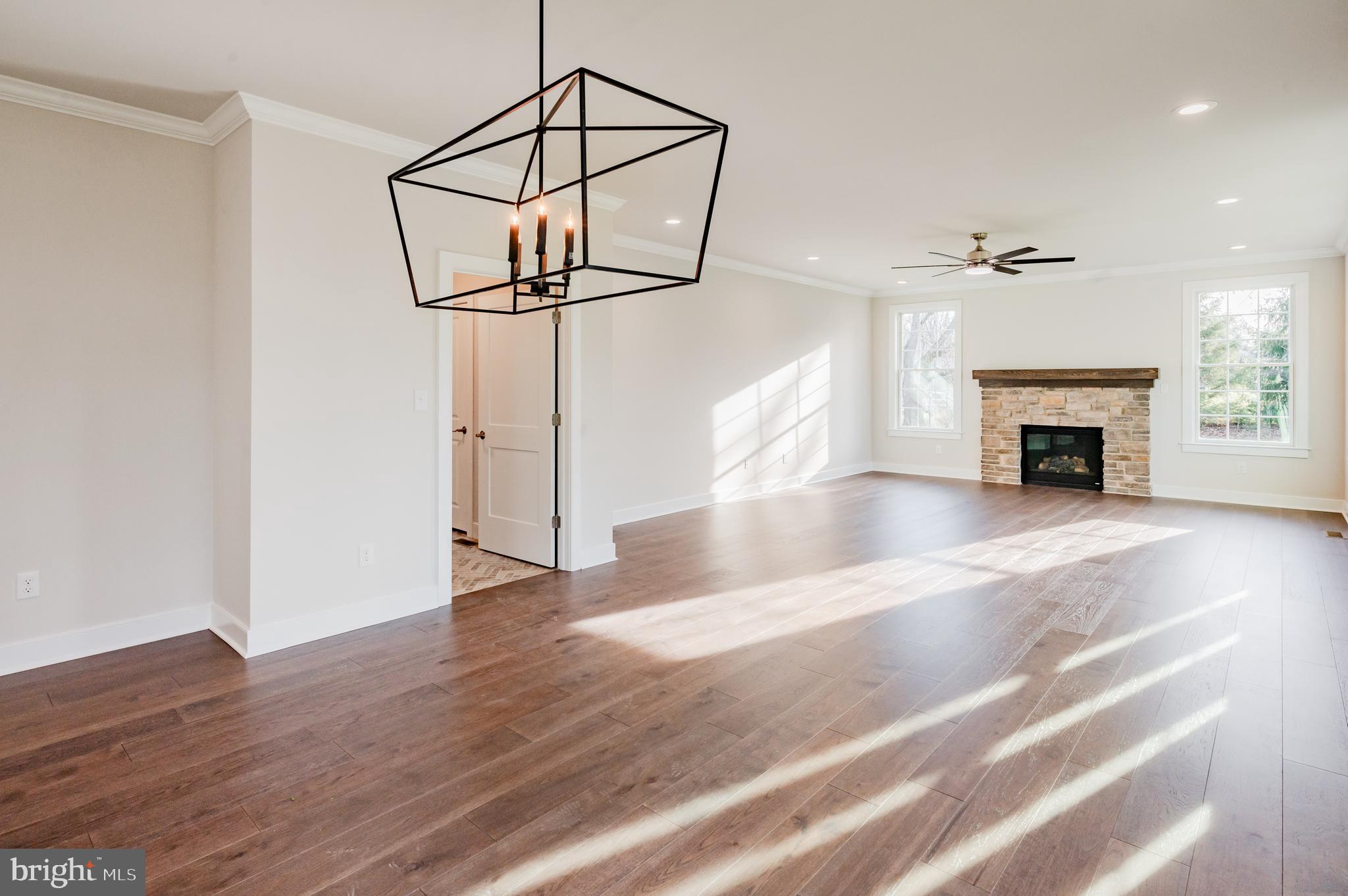 114 Orchard Road Perkasie, PA 18944 - Photo 10 of 17 an empty room with wooden floor fireplace and windows