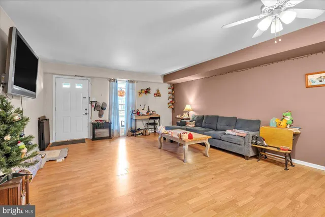 a living room with furniture and a flat screen tv
