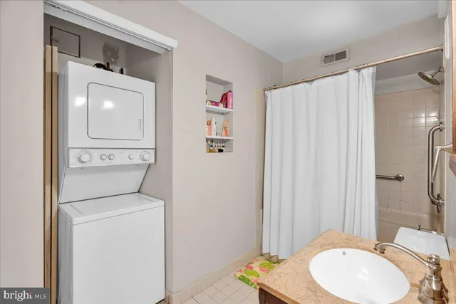 a bathroom with a toilet a sink and shower