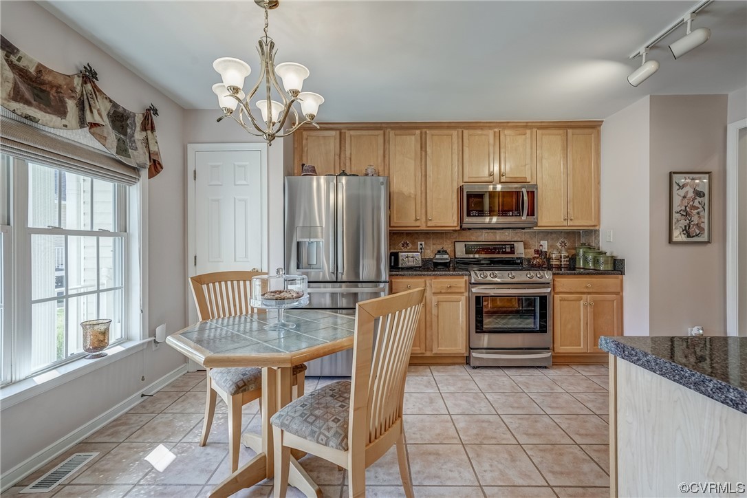 1402 Quiet Lake Loop Midlothian, VA 23114 - Photo 11 of 50 a kitchen with kitchen island granite countertop a stove top oven a sink dishwasher a dining table and chairs with wooden floor
