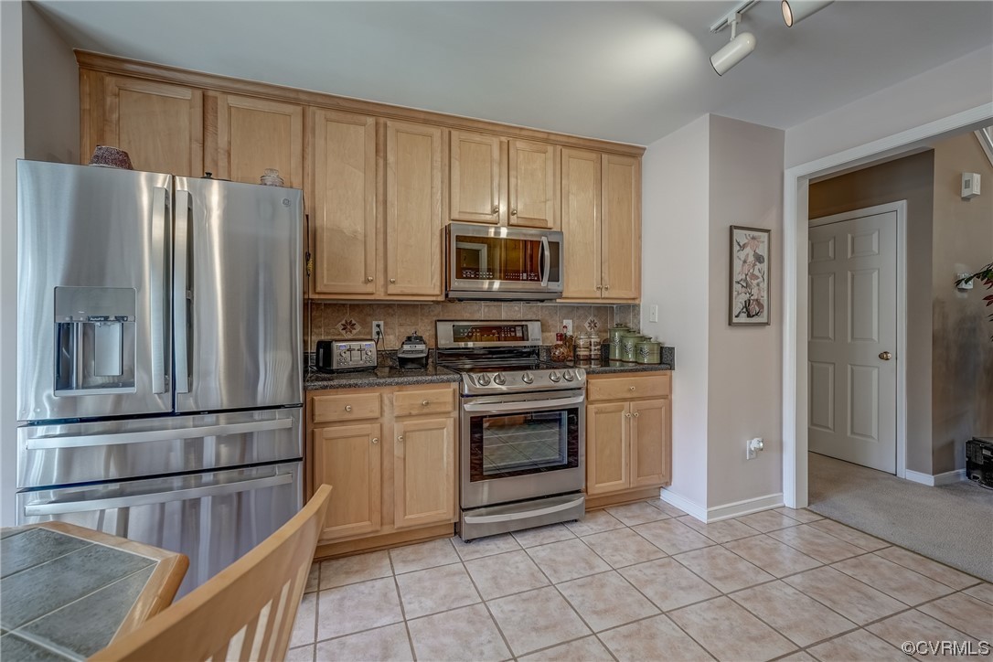 1402 Quiet Lake Loop Midlothian, VA 23114 - Photo 18 of 50 a kitchen with stainless steel appliances granite countertop a refrigerator and a stove top oven