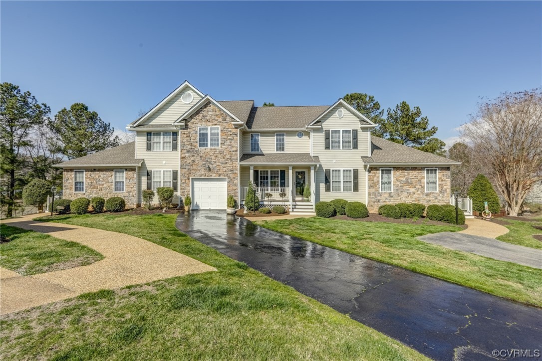 1402 Quiet Lake Loop Midlothian, VA 23114 - Photo 2 of 50 a front view of a house with a yard and garage