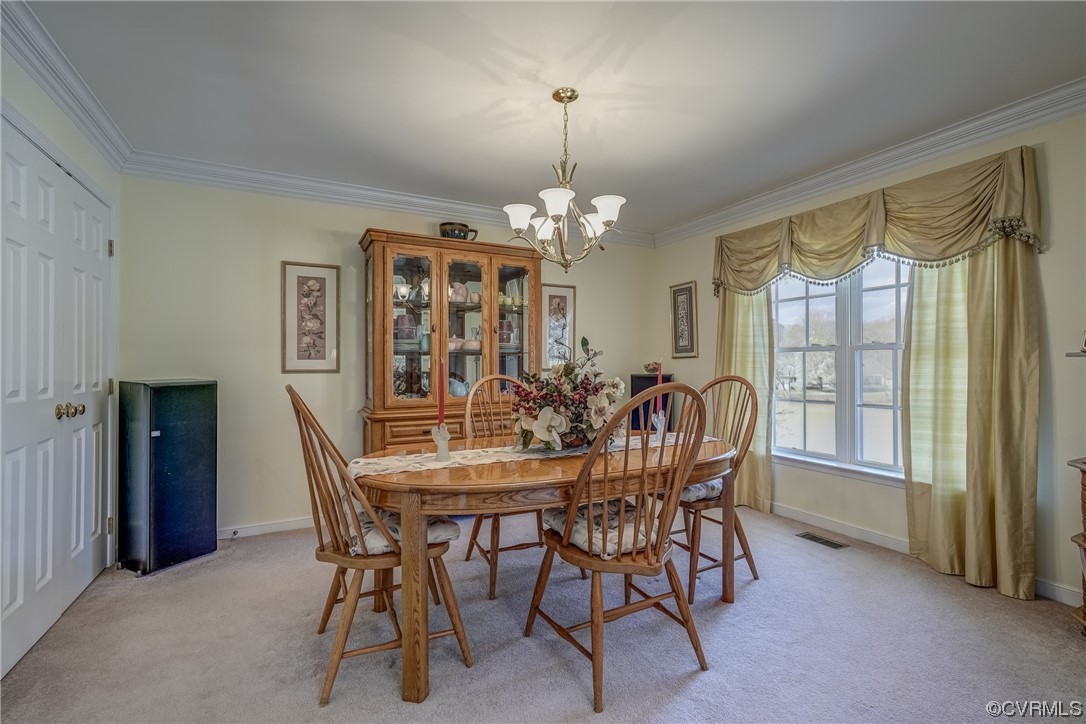 1402 Quiet Lake Loop Midlothian, VA 23114 - Photo 26 of 50 a view of a dining room with furniture window and outside view
