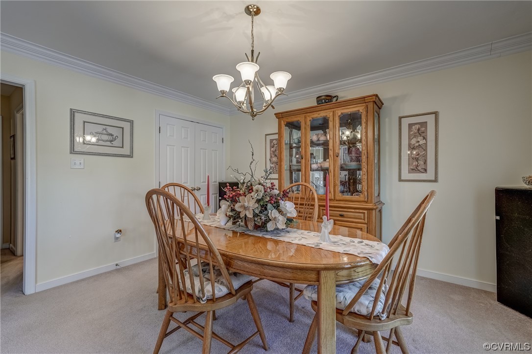 1402 Quiet Lake Loop Midlothian, VA 23114 - Photo 27 of 50 a view of a dining room with furniture and chandelier