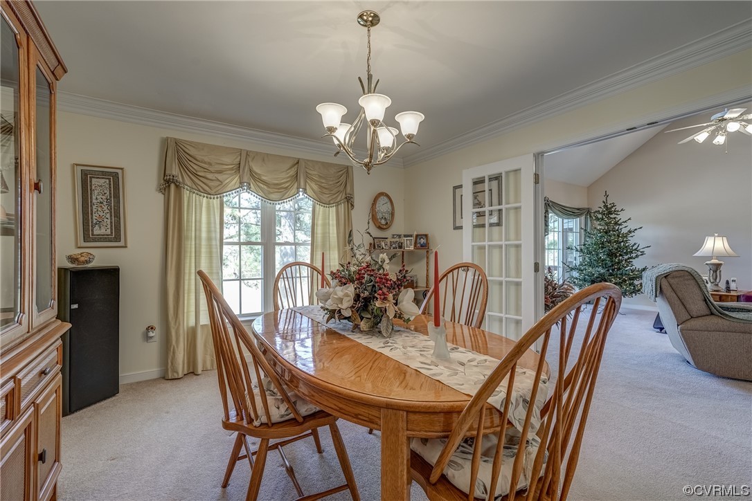 1402 Quiet Lake Loop Midlothian, VA 23114 - Photo 28 of 50 a view of a dining room with furniture a chandelier and wooden floor