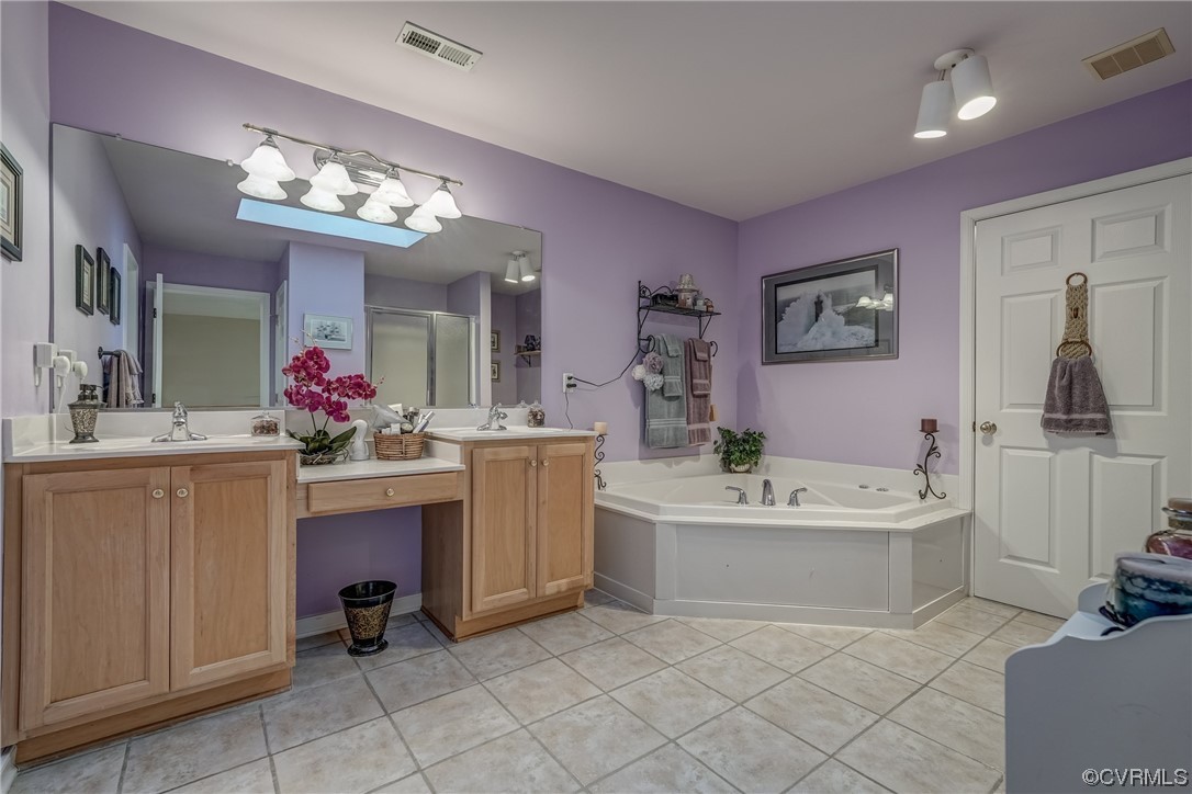 1402 Quiet Lake Loop Midlothian, VA 23114 - Photo 38 of 50 a spacious bathroom with a sink a large mirror and a bathtub