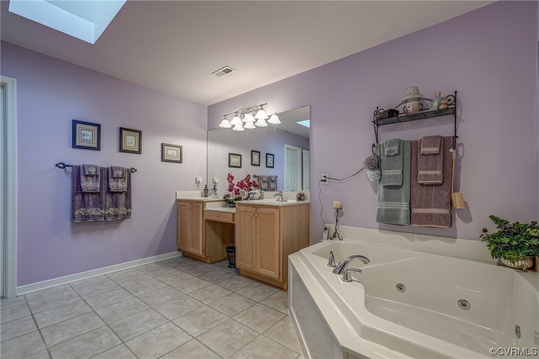 1402 Quiet Lake Loop Midlothian, VA 23114 - Photo 39 of 50 a bathroom with a tub a sink and mirror