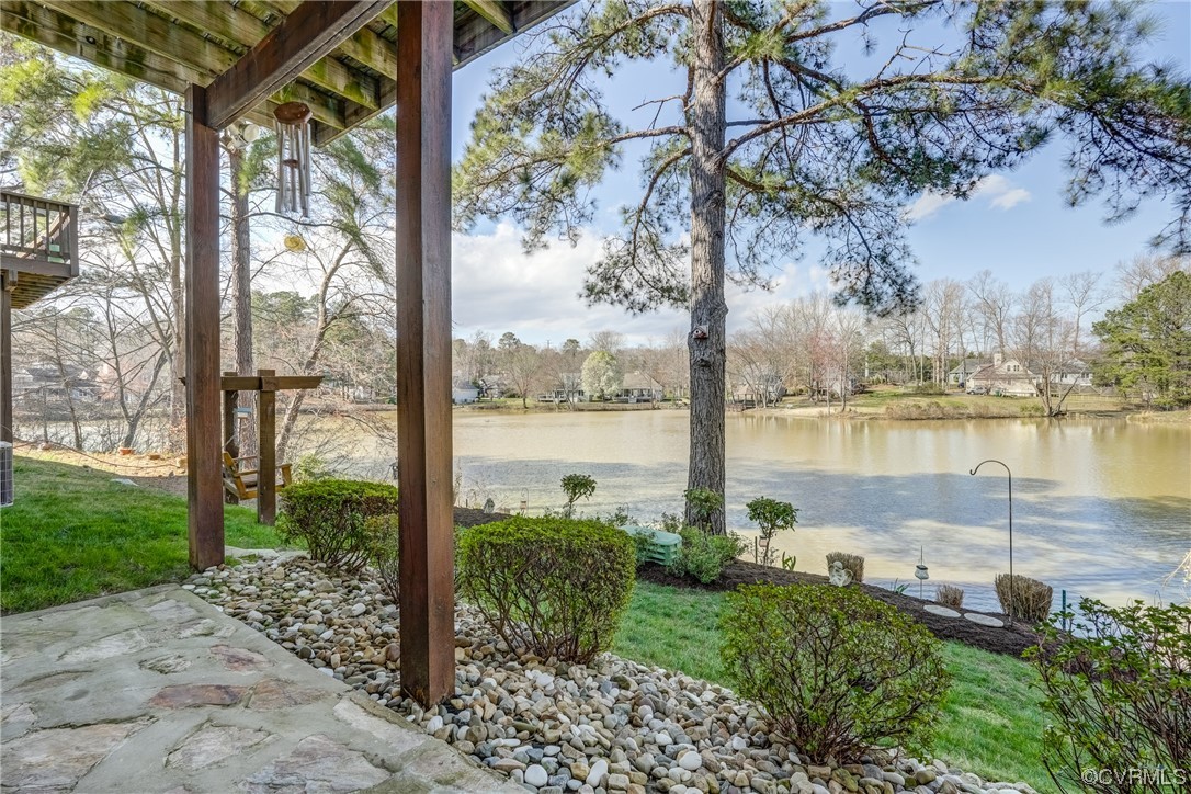 1402 Quiet Lake Loop Midlothian, VA 23114 - Photo 45 of 50 a view of a lake from a yard with potted plants