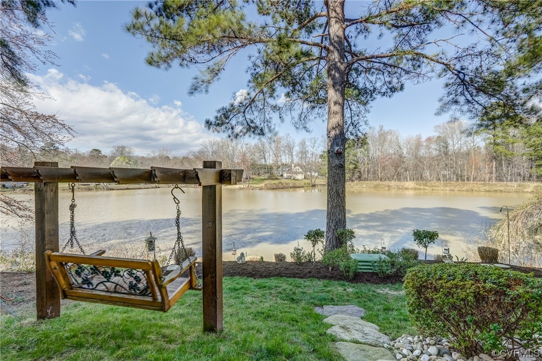 1402 Quiet Lake Loop Midlothian, VA 23114 - Photo 47 of 50 a view of a lake with a big yard and large trees