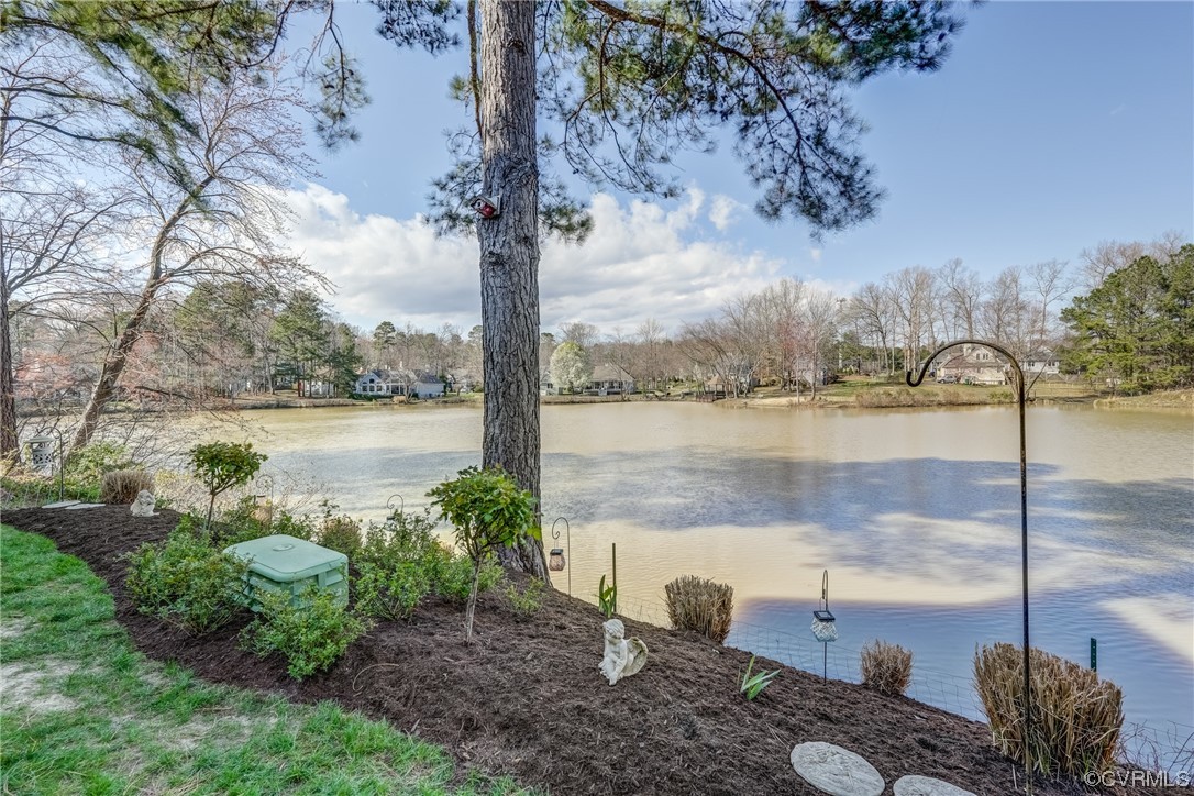 1402 Quiet Lake Loop Midlothian, VA 23114 - Photo 49 of 50 a view of a lake with a floor to ceiling windows and wooden fence