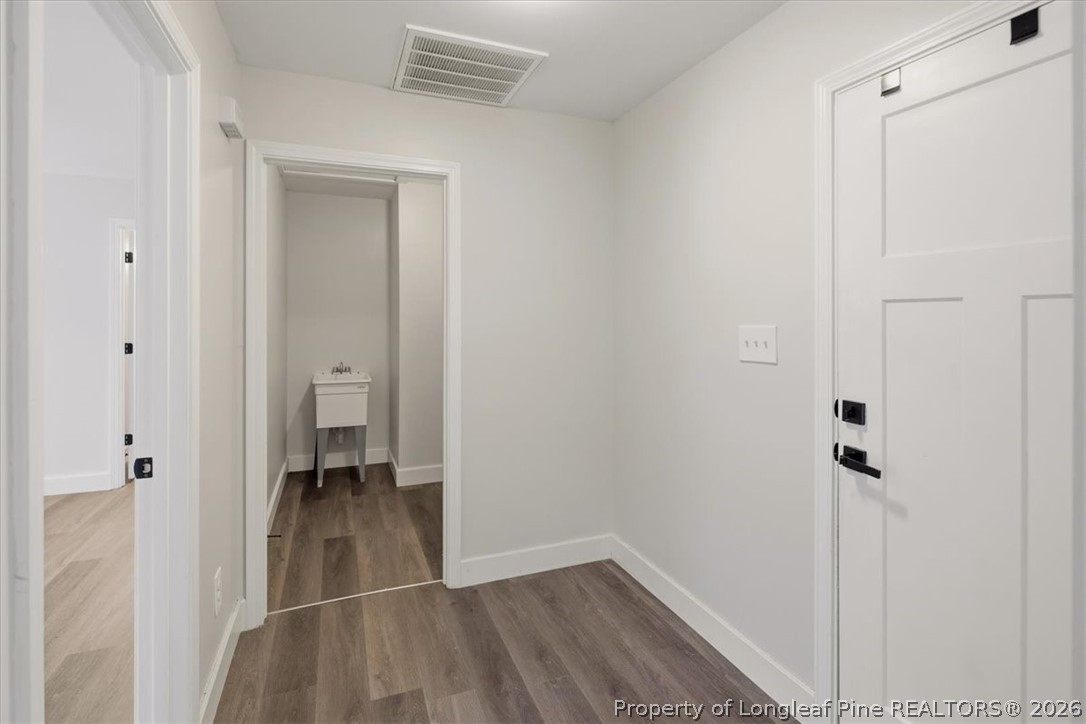 170 Starlight Road Lillington, NC 27546 - Photo 18 of 37 a view of a hallway with wooden floor and closet area