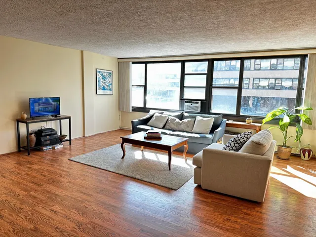 a living room with furniture and a large window
