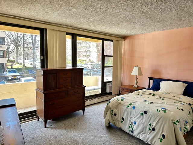a bedroom with a bed and window
