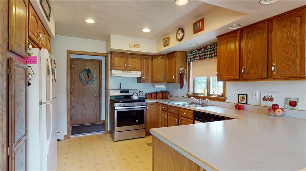 1948 Old State Road Waterford, PA 16441 - Photo 8 of 20 a kitchen with stainless steel appliances granite countertop a sink a stove and refrigerator