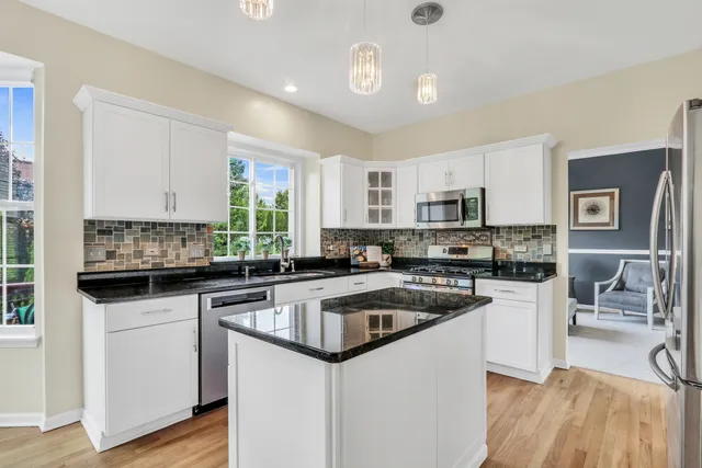 a kitchen with granite countertop a sink and cabinets