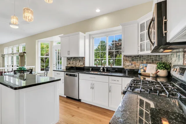 a kitchen with sink and stove top oven