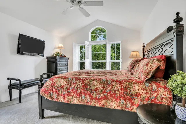 a bed sitting in a bedroom and a flat screen tv