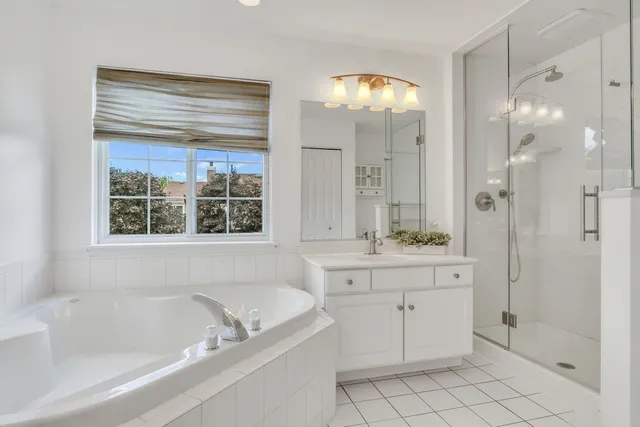 a bathroom with a tub sink and mirror