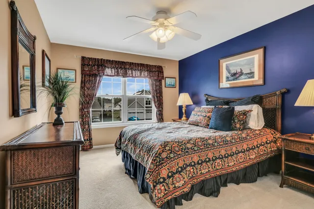 a bedroom with a large bed and a chandelier