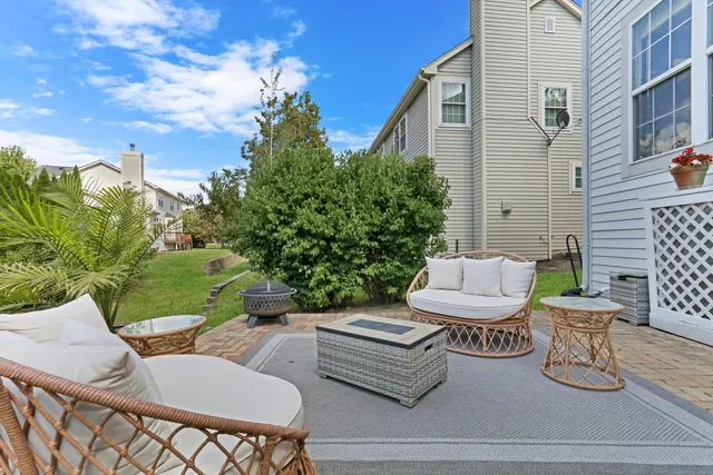 a view of a patio with couches table and chairs and potted plants
