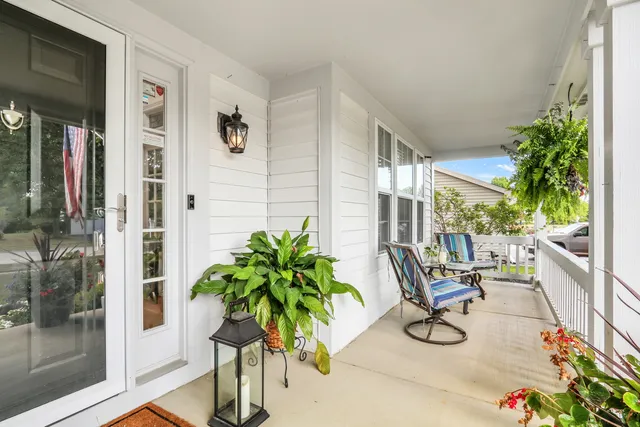 a living room filled with furniture and a potted plant