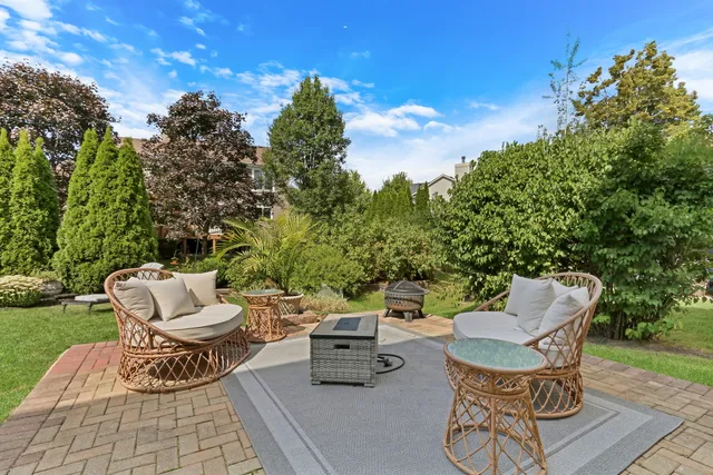 a view of a patio with a chairs and potted plants