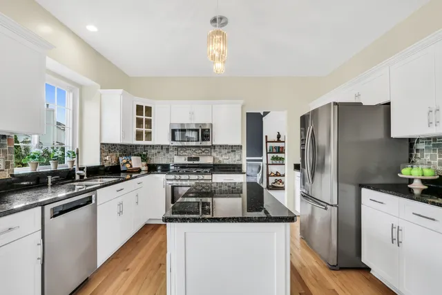 a kitchen with stainless steel appliances a sink stove and refrigerator