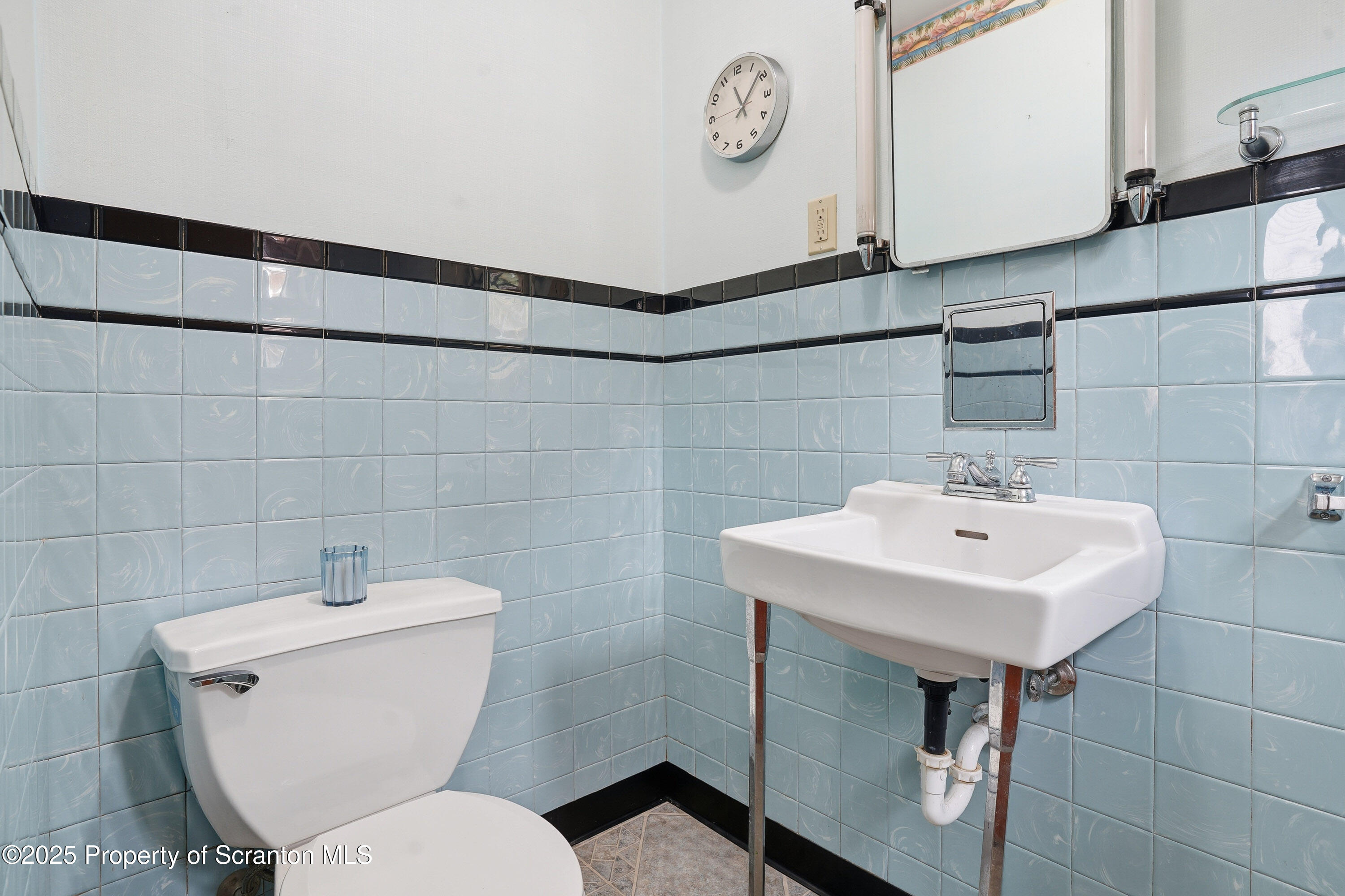 123 William Street Scranton, PA 18510 - Photo 14 of 25 a bathroom with a toilet a sink and a mirror
